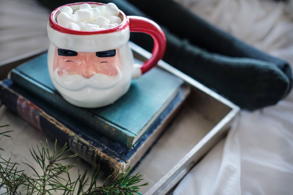 Happy Santa hot chocolate mug on two books